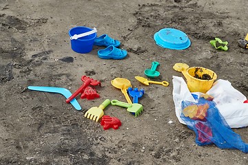 Image showing Plastic xhild toys on the beach