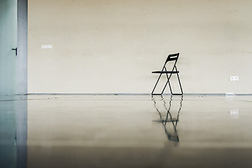 Image showing Lonely black chair at the empty dancing hall