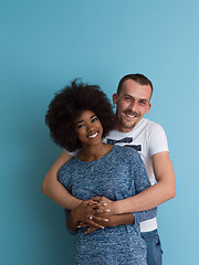 Image showing multiethnic couple laughing and hugging