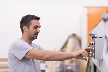 Image showing worker in a factory of wooden furniture