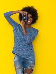 Image showing young african american girl taking photo on a retro camera