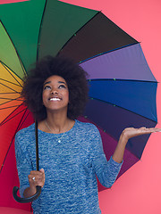 Image showing afro american woman holding a colorful umbrella