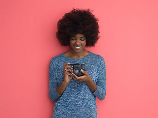 Image showing young black girl taking photo on a retro camera