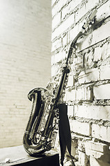 Image showing Saxophone On The Brick Wall Background - Vintage Toned Image