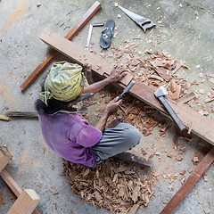 Image showing Carpenter working in traditional manual carpentry shop in a third world country.