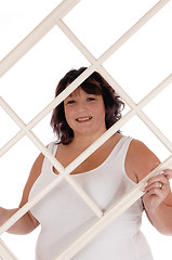 Image showing Big woman holding window frame