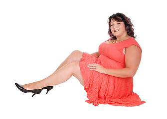 Image showing Overweight woman sitting on floor
