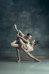 Image showing The young modern ballet dancers posing on gray studio background