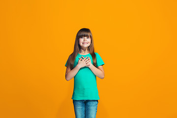 Image showing Beautiful teen girl looking suprised isolated on orange