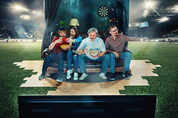 Image showing Soccer football fans sitting on the sofa and watching TV in the 