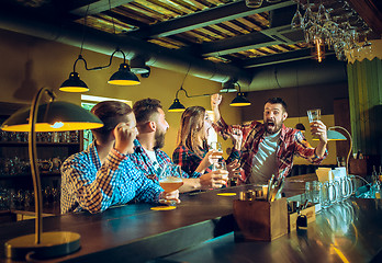 Image showing Sport, people, leisure, friendship and entertainment concept - happy football fans or male friends drinking beer and celebrating victory at bar or pub