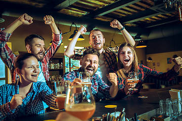 Image showing Sport, people, leisure, friendship and entertainment concept - happy football fans or male friends drinking beer and celebrating victory at bar or pub