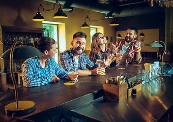 Image showing Sport, people, leisure, friendship and entertainment concept - happy football fans or male friends drinking beer and celebrating victory at bar or pub