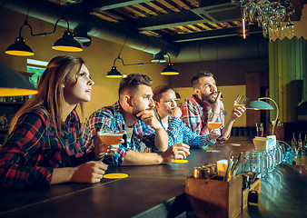 Image showing Sport, people, leisure, friendship and entertainment concept - happy football fans or male friends drinking beer and celebrating victory at bar or pub