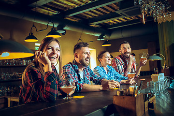 Image showing Sport, people, leisure, friendship and entertainment concept - happy football fans or male friends drinking beer and celebrating victory at bar or pub