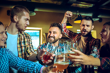 Image showing Sport, people, leisure, friendship and entertainment concept - happy football fans or male friends drinking beer and celebrating victory at bar or pub