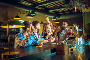 Image showing Sport, people, leisure, friendship and entertainment concept - happy football fans or male friends drinking beer and celebrating victory at bar or pub