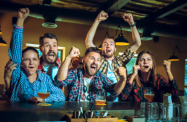 Image showing Sport, people, leisure, friendship and entertainment concept - happy football fans or male friends drinking beer and celebrating victory at bar or pub