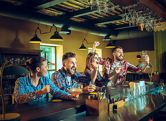 Image showing Sport, people, leisure, friendship and entertainment concept - happy football fans or male friends drinking beer and celebrating victory at bar or pub