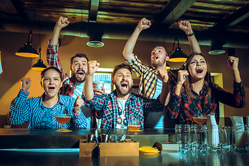 Image showing Sport, people, leisure, friendship and entertainment concept - happy football fans or male friends drinking beer and celebrating victory at bar or pub