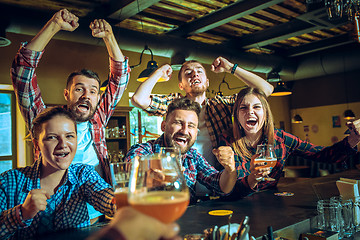 Image showing Sport, people, leisure, friendship and entertainment concept - happy football fans or male friends drinking beer and celebrating victory at bar or pub