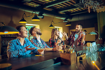 Image showing Sport, people, leisure, friendship and entertainment concept - happy football fans or male friends drinking beer and celebrating victory at bar or pub