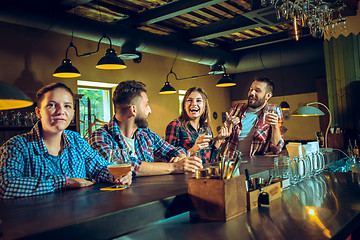 Image showing Sport, people, leisure, friendship and entertainment concept - happy football fans or male friends drinking beer and celebrating victory at bar or pub