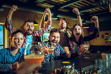 Image showing Sport, people, leisure, friendship and entertainment concept - happy football fans or male friends drinking beer and celebrating victory at bar or pub