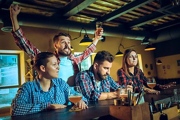 Image showing Sport, people, leisure, friendship and entertainment concept - happy football fans or male friends drinking beer and celebrating victory at bar or pub