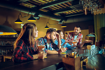 Image showing Sport, people, leisure, friendship and entertainment concept - happy football fans or male friends drinking beer and celebrating victory at bar or pub