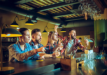 Image showing Sport, people, leisure, friendship and entertainment concept - happy football fans or male friends drinking beer and celebrating victory at bar or pub