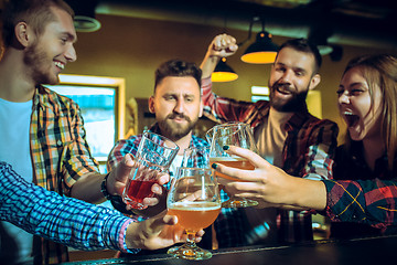 Image showing Sport, people, leisure, friendship and entertainment concept - happy football fans or male friends drinking beer and celebrating victory at bar or pub