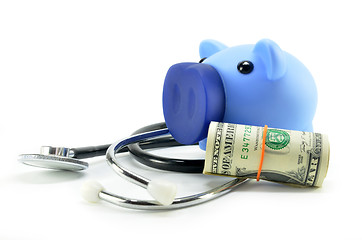 Image showing Stethoscope and piggy bank