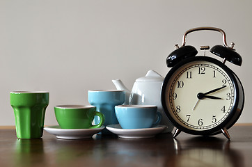 Image showing Alarm clock with colorful tea set