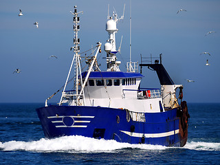 Image showing Blue Fishing Boat at Speed.