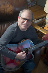 Image showing middle age senior man playing acoustic guitar