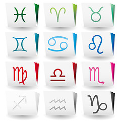 Image showing Set of folders with white covers and colored pages with zodiac signs 