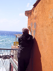 Image showing man looking at sea by old waterfront building Riomaggiore Cinque