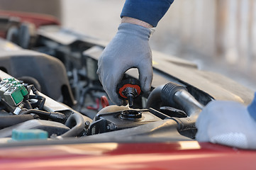 Image showing engine oil changing at car with liquefied petroleum gas system