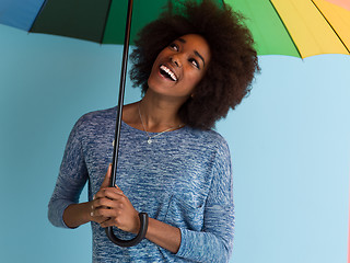 Image showing beautiful black woman holding a colorful umbrella