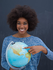 Image showing black woman holding Globe of the world