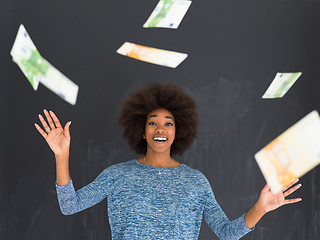 Image showing black woman throwing money