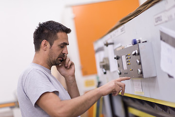 Image showing engineer in front of wood cutting machine