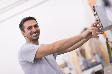 Image showing worker in a factory of wooden furniture