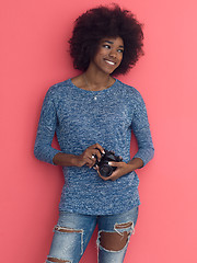 Image showing young black girl taking photo on a retro camera