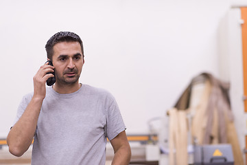 Image showing engineer in front of wood cutting machine