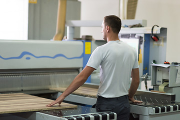 Image showing worker in a factory of wooden furniture