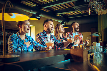 Image showing Sport, people, leisure, friendship and entertainment concept - happy football fans or male friends drinking beer and celebrating victory at bar or pub