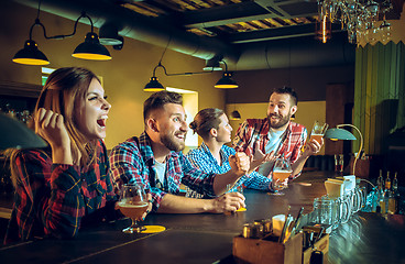 Image showing Sport, people, leisure, friendship and entertainment concept - happy football fans or male friends drinking beer and celebrating victory at bar or pub