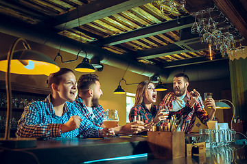 Image showing Sport, people, leisure, friendship and entertainment concept - happy football fans or male friends drinking beer and celebrating victory at bar or pub